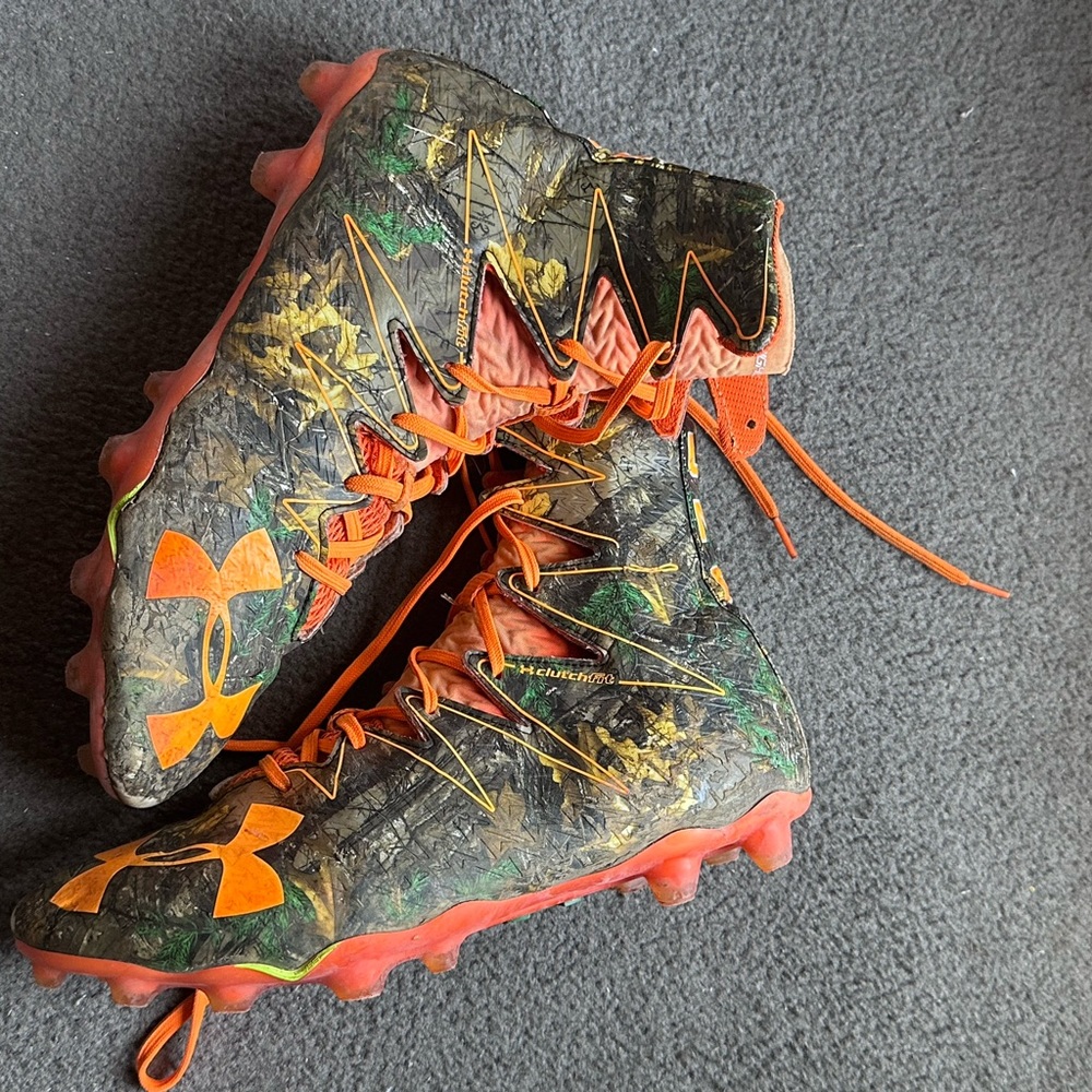 Camouflaged football cleats with orange